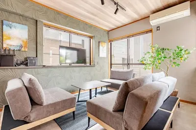 a living room with two chairs and a tv at \u6771\u5dba\u753a47 in Tokyo