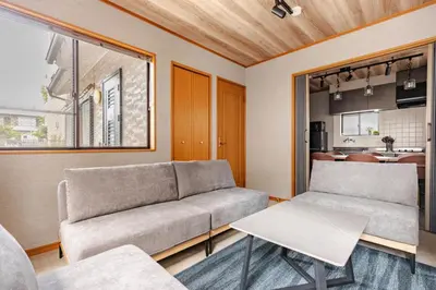 a living room with a couch and a table at \u6771\u5dba\u753a47 in Tokyo