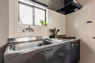 a kitchen with a stainless steel sink and a stove at \u6771\u5dba\u753a47 in Tokyo