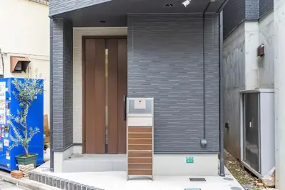 a front door of a house with a refrigerator at Bear Bear House 1-Min Walk to the Station in Tokyo