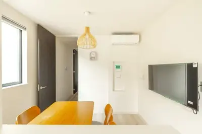 a dining room with a wooden table and chairs at Bear Bear House 1-Min Walk to the Station in Tokyo