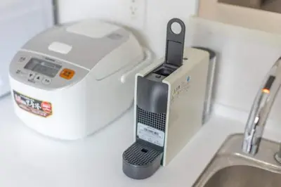 a cell phone holder on a counter next to a sink at Bear Bear House 1-Min Walk to the Station in Tokyo