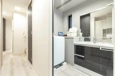 a white bathroom with a sink and a mirror at Bear Bear House 1-Min Walk to the Station in Tokyo