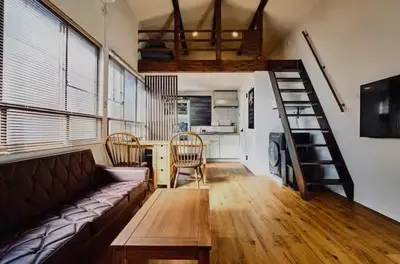 a living room with a couch and a table and a staircase at Tokyo Base \u6674\u7a7a\u6a39 2BR Loft Stylish House Asakusa SkyTree Area in Tokyo