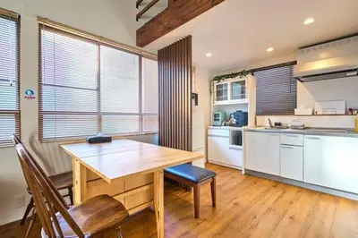 a large kitchen with a wooden table and chairs at Tokyo Base \u6674\u7a7a\u6a39 2BR Loft Stylish House Asakusa SkyTree Area in Tokyo