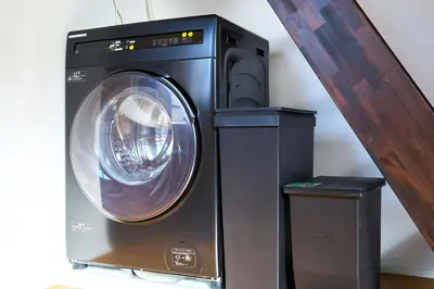 a dryer next to a washer and a wooden staircase at Tokyo Base \u6674\u7a7a\u6a39 2BR Loft Stylish House Asakusa SkyTree Area in Tokyo