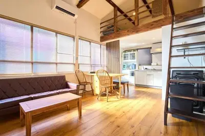 a living room with a couch and a table at Tokyo Base \u6674\u7a7a\u6a39 2BR Loft Stylish House Asakusa SkyTree Area in Tokyo
