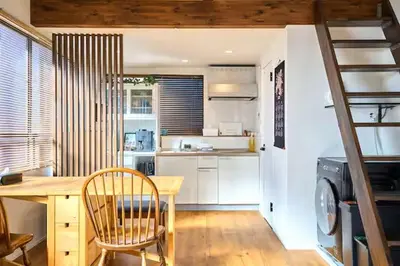 a kitchen with a wooden table and a kitchen with a stair at Tokyo Base \u6674\u7a7a\u6a39 2BR Loft Stylish House Asakusa SkyTree Area in Tokyo