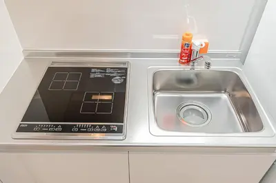 a kitchen counter with a sink and a microwave at Japan House Komagome Apartment\u65b0\u7bc9\u99d2\u8fbc\u99c5\u5f92\u6b695\u5206 in Tokyo