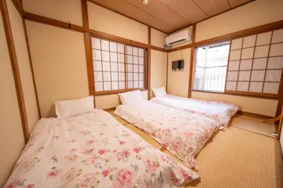 two beds in a room with two windows at Tokyo cozy house-Direct to ginza shibuya shinjuku in Tokyo