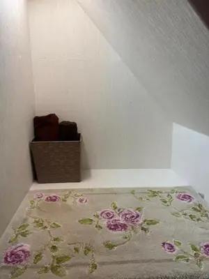 a room with a bed with a flower rug on it at Tokyo cozy house-Direct to ginza shibuya shinjuku in Tokyo