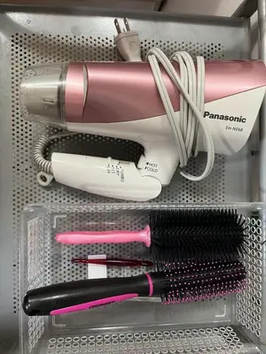 a drawer with several hairbrushes and other items in it at Tokyo cozy house-Direct to ginza shibuya shinjuku in Tokyo