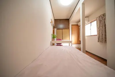 a large bed in a room with a table at Tokyo cozy house-Direct to ginza shibuya shinjuku in Tokyo