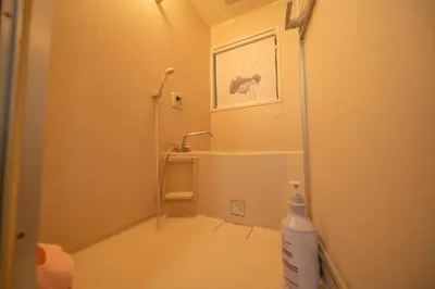 a small bathroom with a shower and a sink at Tokyo cozy house-Direct to ginza shibuya shinjuku in Tokyo