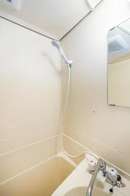 a bathroom with a white sink and a mirror at Ikebukuro 8 min walk, Kanamecho 6 min walk, 25sqm room, 2 guests, Direct access to Shinjuku, Shibuya, Tokyo, Ueno, 2 single beds in Tokyo