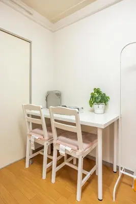 a white table with two chairs and a potted plant at Ikebukuro 8 min walk, Kanamecho 6 min walk, 25sqm room, 2 guests, Direct access to Shinjuku, Shibuya, Tokyo, Ueno, 2 single beds in Tokyo