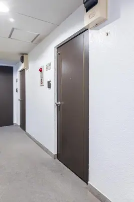 a row of doors in a hallway in an office at Ikebukuro 8 min walk, Kanamecho 6 min walk, 25sqm room, 2 guests, Direct access to Shinjuku, Shibuya, Tokyo, Ueno, 3 single beds in Tokyo