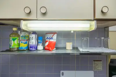 a shelf in a kitchen with various items on it at Ikebukuro 8 min walk, Kanamecho 6 min walk, 25sqm room, 2 guests, Direct access to Shinjuku, Shibuya, Tokyo, Ueno, 3 single beds in Tokyo