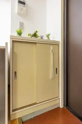 a cabinet with plants on top of it in a room at Ikebukuro 8 min walk, Kanamecho 6 min walk, 25sqm room, 2 guests, Direct access to Shinjuku, Shibuya, Tokyo, Ueno, 3 single beds in Tokyo