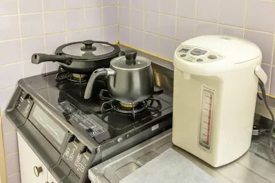 a stove with a pot on top of it at Ikebukuro 8 min walk, Kanamecho 6 min walk, 25sqm room, 2 guests, Direct access to Shinjuku, Shibuya, Tokyo, Ueno, 3 single beds in Tokyo
