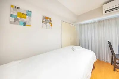 a white bedroom with a bed and a window at Ikebukuro 8 min walk, Kanamecho 6 min walk, 25sqm room, 2 guests, Direct access to Shinjuku, Shibuya, Tokyo, Ueno, 3 single beds in Tokyo