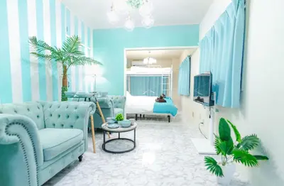 a blue living room with a couch and a bed at Max 9 people 3 min taxi Ikebukuro Station Tiffany Blue yellow Room \u6700\u59279\u540d \u6c60\u888b in Tokyo