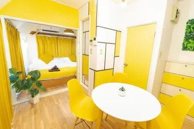 a small room with a table and yellow chairs at Max 9 people 3 min taxi Ikebukuro Station Tiffany Blue yellow Room \u6700\u59279\u540d \u6c60\u888b in Tokyo