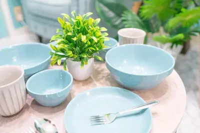a table with blue bowls and forks and plants at Max 9 people 3 min taxi Ikebukuro Station Tiffany Blue yellow Room \u6700\u59279\u540d \u6c60\u888b in Tokyo