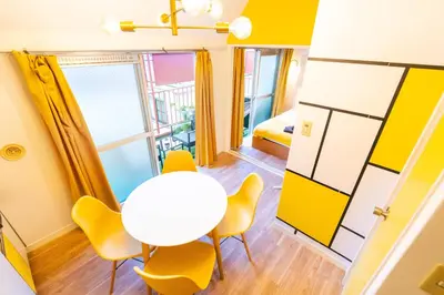 a room with a table and chairs and a bed at Max 9 people 3 min taxi Ikebukuro Station Tiffany Blue yellow Room \u6700\u59279\u540d \u6c60\u888b in Tokyo