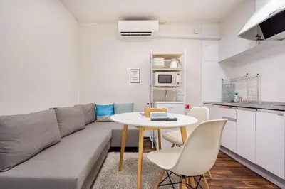 a living room with a couch and a table at \u30a2\u30f3\u30c9\u30b9\u30c6\u30a4\u4e0a\u5341\u67613\u4e01\u76ee in Tokyo
