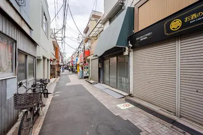 an alley with a bike parked next to buildings at \u30a2\u30f3\u30c9\u30b9\u30c6\u30a4\u4e0a\u5341\u67613\u4e01\u76ee in Tokyo