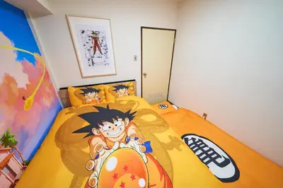 a bedroom with a bed with a painting on it at Kan'eiji-zaka Heim 寛永寺坂ハイム in Tokyo