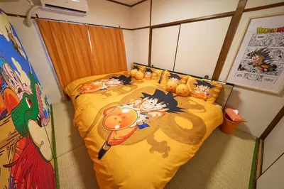 a bedroom with a yellow bed with cats on it at Kan'eiji-zaka Heim 寛永寺坂ハイム in Tokyo