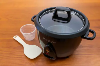 a slow cooker and a spoon on a table at Shinjuku Homely Stay in Tokyo