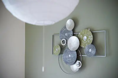 a shelf with plates and vases on a wall at Shinjuku Homely Stay in Tokyo