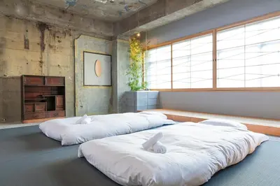 two large white beds in a room with windows at \u30b7\u30ce\u30f3\u8535\u524d CINON Kuramae in Tokyo