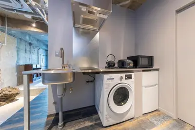 a kitchen with a washing machine and a sink at \u30b7\u30ce\u30f3\u8535\u524d CINON Kuramae in Tokyo