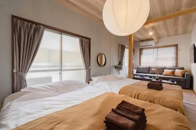a bedroom with two beds and a large window at Aimer202 AI22 in Tokyo