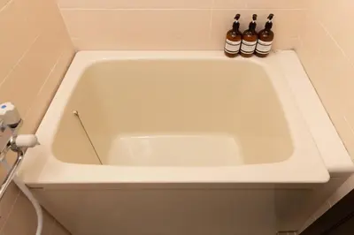a white bath tub with three bottles in it at Aimer202 AI22 in Tokyo