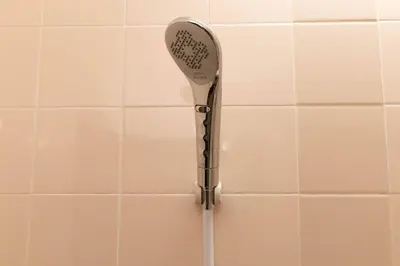 a shower head is hanging on a tiled wall at Aimer202 AI22 in Tokyo
