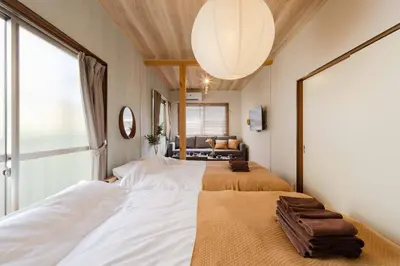 a bedroom with two beds and a large window at Aimer202 AI22 in Tokyo