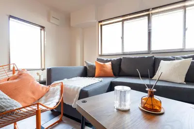 a living room with a couch and a table at Tokyo Stay Aoto in Tokyo