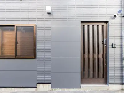 a gray building with a door and a window at Tokyo Stay Aoto in Tokyo
