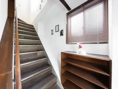 a staircase in a house with white walls and wooden floors at Tokyo Stay Aoto in Tokyo