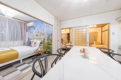 a room with a king sized bed and a balcony at TDR\u8eca9\u5206 3BR 5Bed \u5922\u306e\u7d9a\u304d\u3092\u697d\u3057\u3081\u308b\u5bbf -TAMU-LAND Kasai- in Tokyo