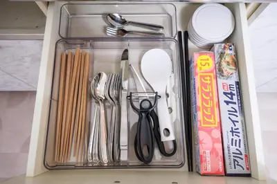 a drawer filled with kitchen utensils and a box at TDR\u8eca9\u5206 3BR 5Bed \u5922\u306e\u7d9a\u304d\u3092\u697d\u3057\u3081\u308b\u5bbf -TAMU-LAND Kasai- in Tokyo