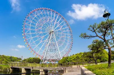a ferris wheel in a park next to a bridge at TDR\u8eca9\u5206 3BR 5Bed \u5922\u306e\u7d9a\u304d\u3092\u697d\u3057\u3081\u308b\u5bbf -TAMU-LAND Kasai- in Tokyo