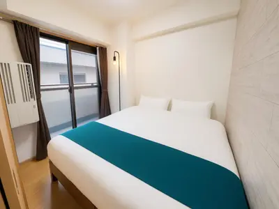 a bedroom with a white bed and a window at Shinjuku,5min Walk to Higashi-Shinjuku sta & Shinjuku Sta,King Bed,ree Wi-Fi in Tokyo