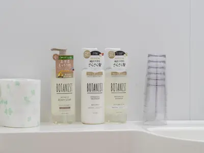 a shelf with four bottles of products on it at Shinjuku,5min Walk to Higashi-Shinjuku sta & Shinjuku Sta,King Bed,ree Wi-Fi in Tokyo