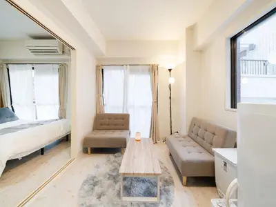 a living room with a couch and a table at Shinjuku,5min Walk to Higashi-Shinjuku sta & Shinjuku Sta,King Bed,ree Wi-Fi in Tokyo